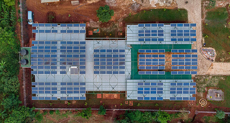 Solar panels in the facility’s courtyard aim to mimic the popular banana trees of the region, whose leaves provide shade from the heat 