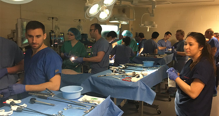 Large group of residents are in a mock-surgical theater to practice surgery