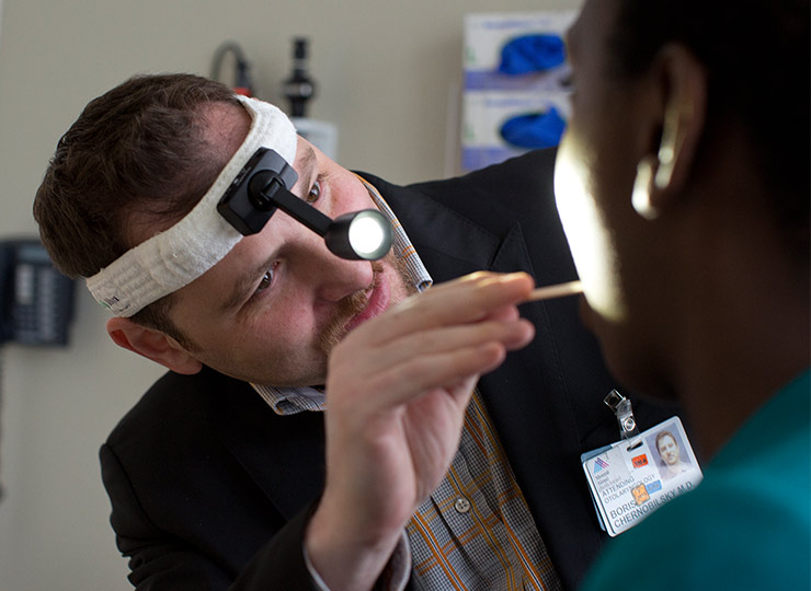 Doctor looking into patient’s throat