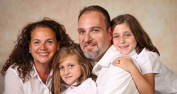 A family portrait of Andrea & Bob Papageorgiou with their daughters Ava and Olivia